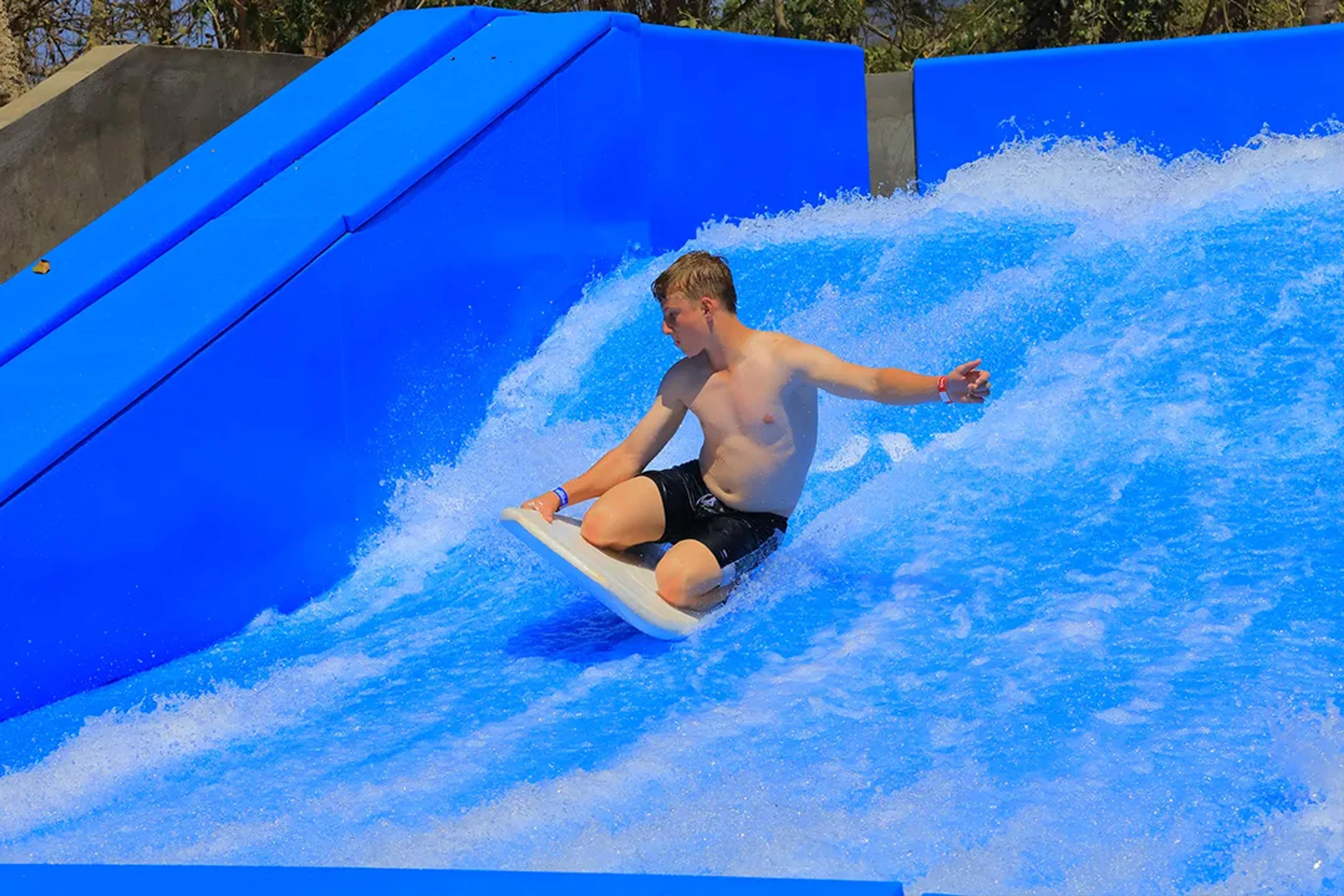 Surf an artificial wave on a FlowRider in Puerto Vallarta, enjoying a thrilling water adventure experience.
