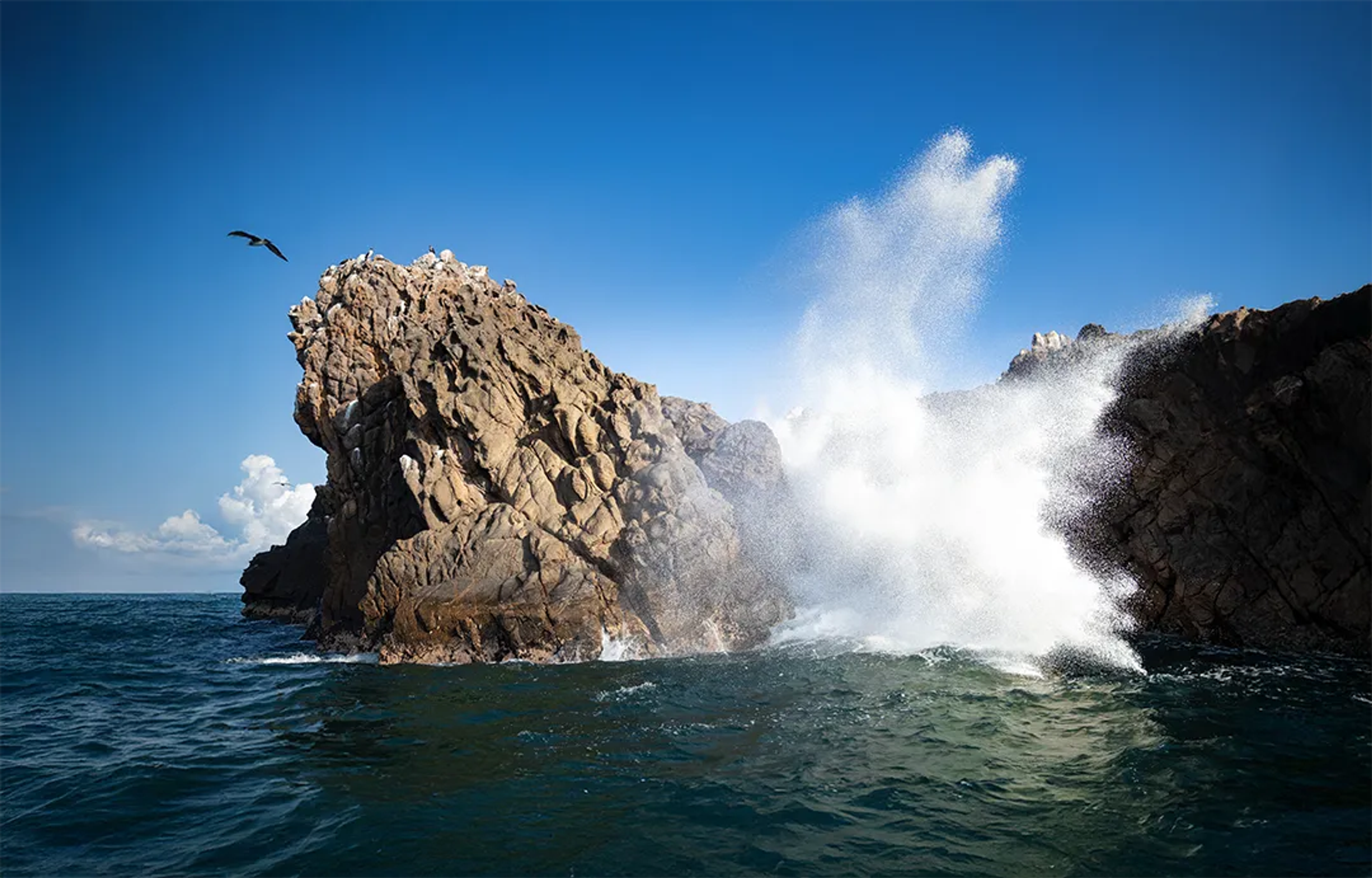 Spectacular wave crushing at one of Marietas Islands' blowholes.