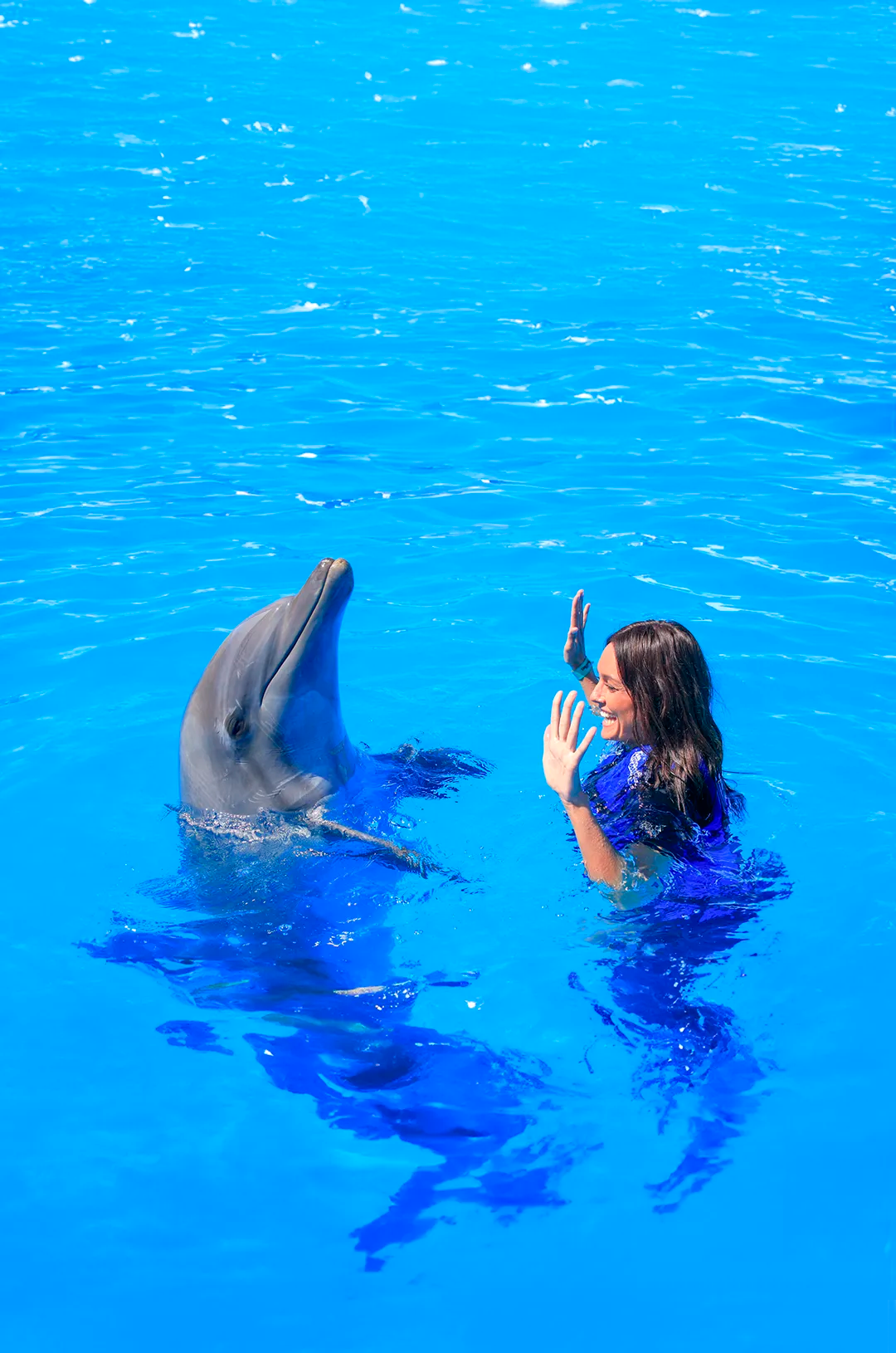Girl practicing dolphin communication with hand signals.