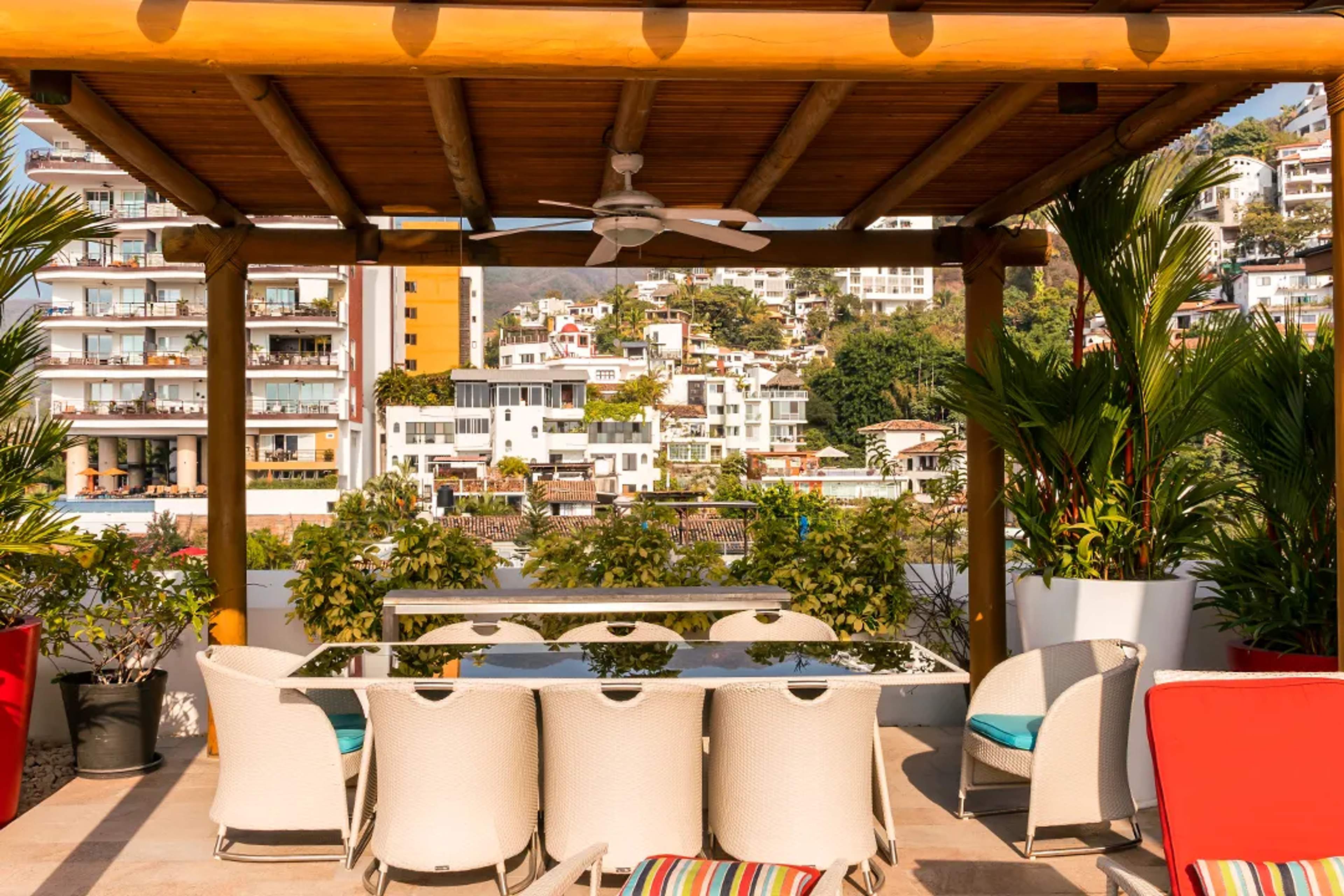Rooftop terrace dining with city and jungle views in Puerto Vallarta luxury vacation experience