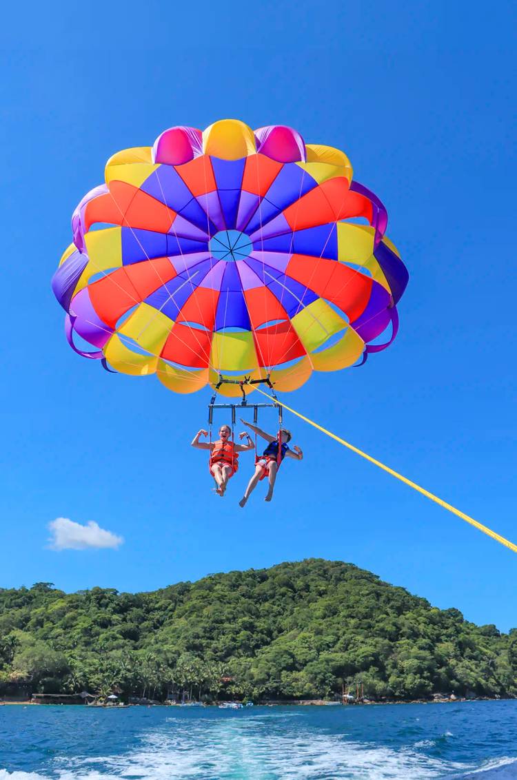 Teenagers flying on a Puerto Vallarta parasailing.
