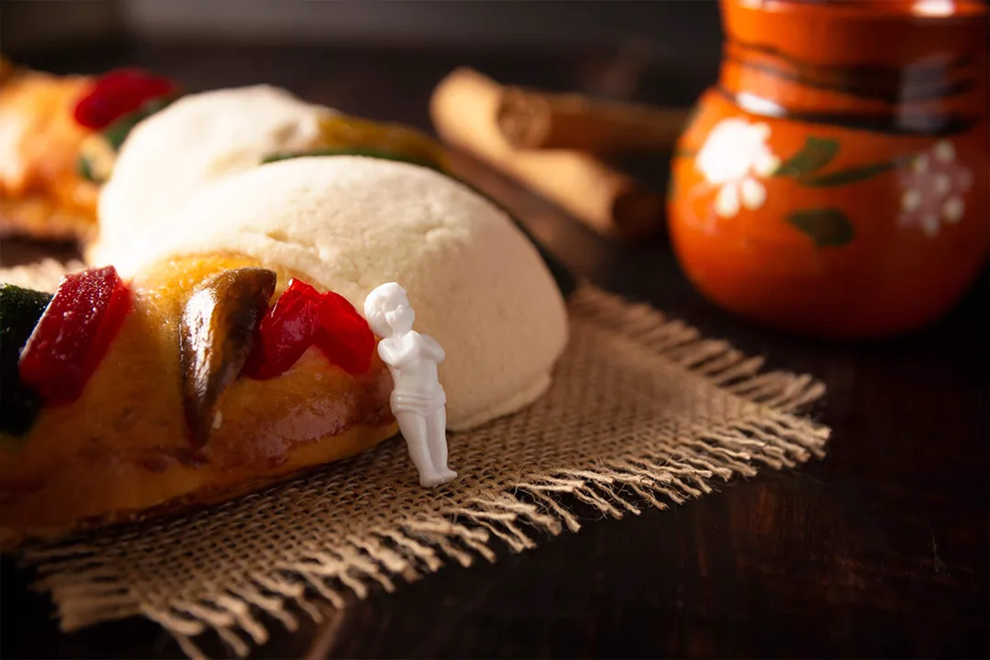 Traditional Rosca de Reyes with candied fruit and hidden figurine, a classic Mexican Three Kings dessert