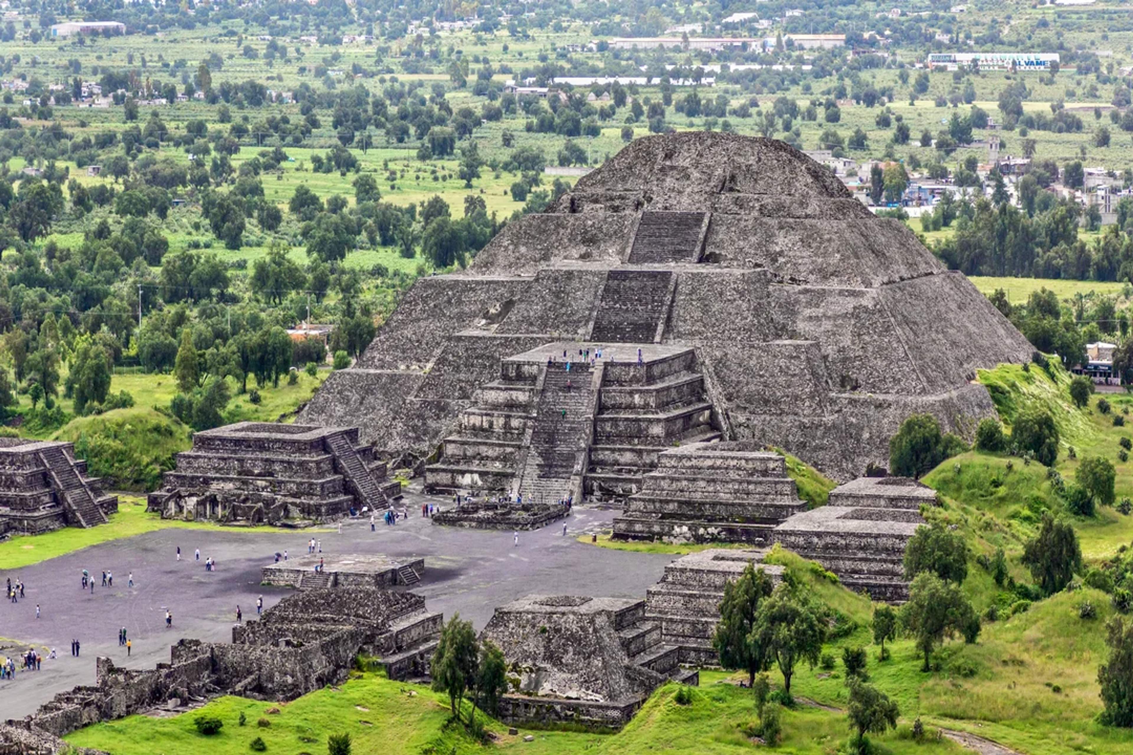 The Pyramid of the Moon in Teotihuacan, an ancient Mesoamerican site surrounded by lush greenery.