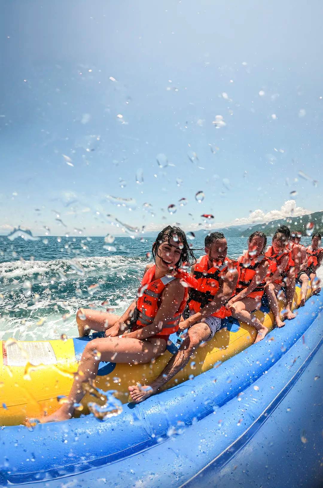Friends enjoying a thrilling banana boat ride in Puerto Vallarta.
