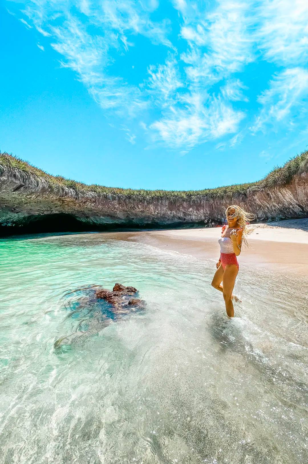 A woman enjoys the clear waters and sandy shore of Hidden Beach, Marietas Islands, one of Mexico's most iconic destinations.