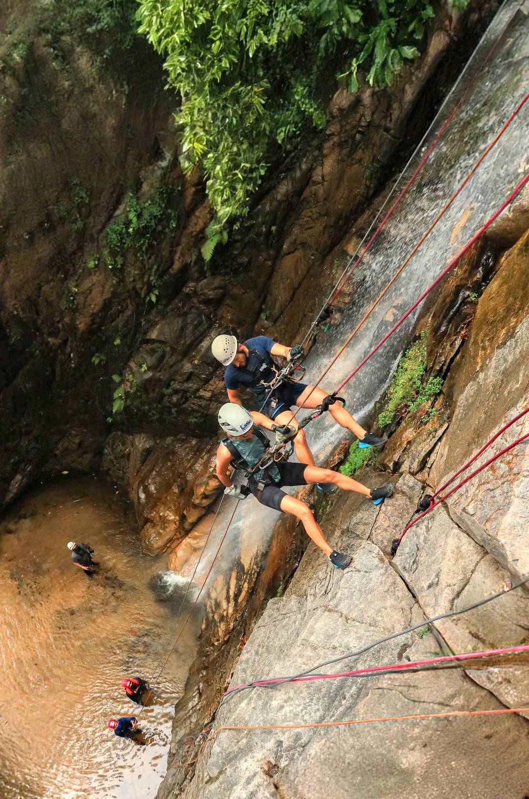 Two people rappel down a waterfall during an Outdoor Adventure in Puerto Vallarta.