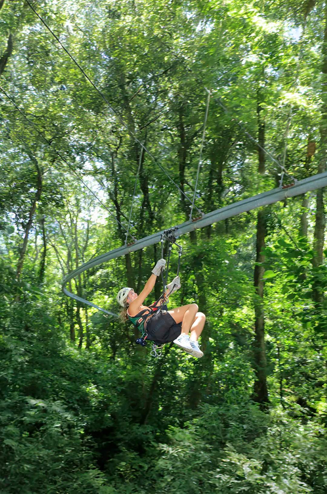 Girl sliding on a Puerto Vallarta zip line rollercoaster.