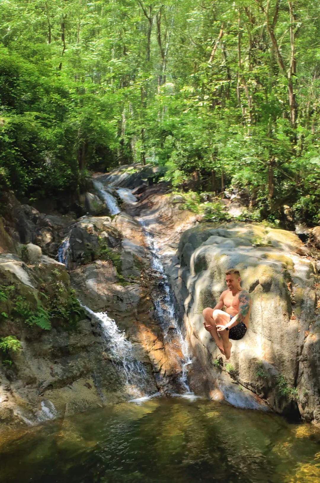 Traveler jumping into one of Puerto Vallarta waterfalls during the All Terrain tour.