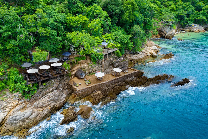 Restaurant by the sea with two little terrases and surrender by blue crystal water