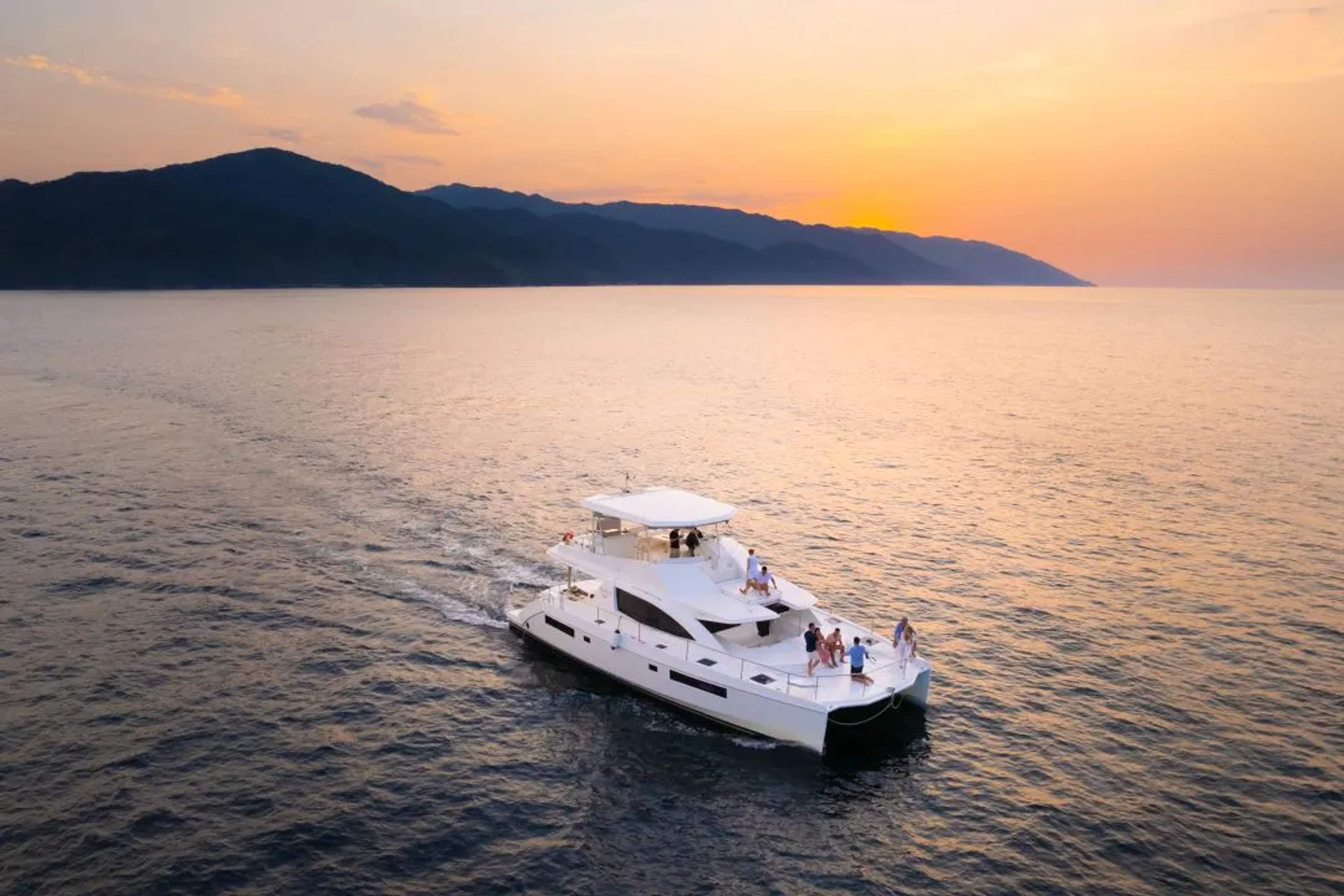 A yacht in the ocean during sunset