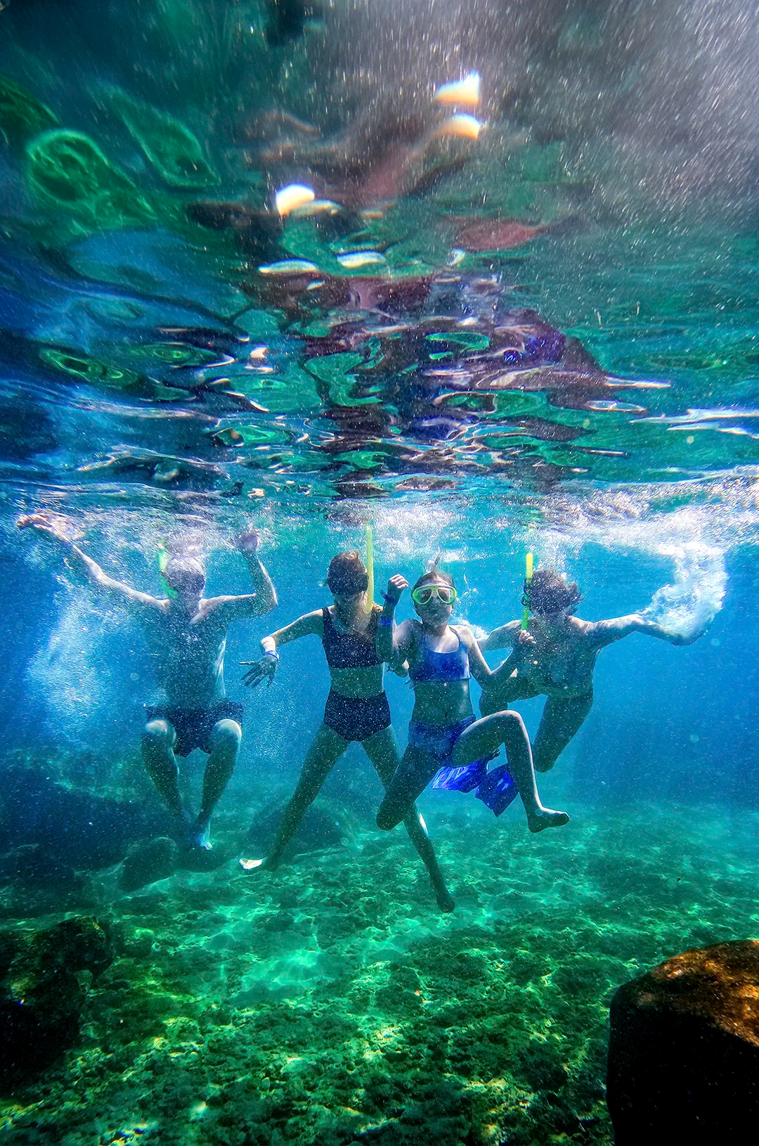Children snorkeling at Las Caletas, one of the best Puerto Vallarta family beaches.