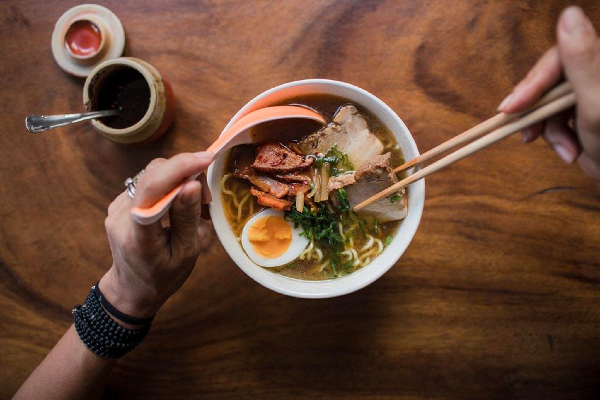 Un plato de ramen con huevo cocido, carne, verduras y fideos.