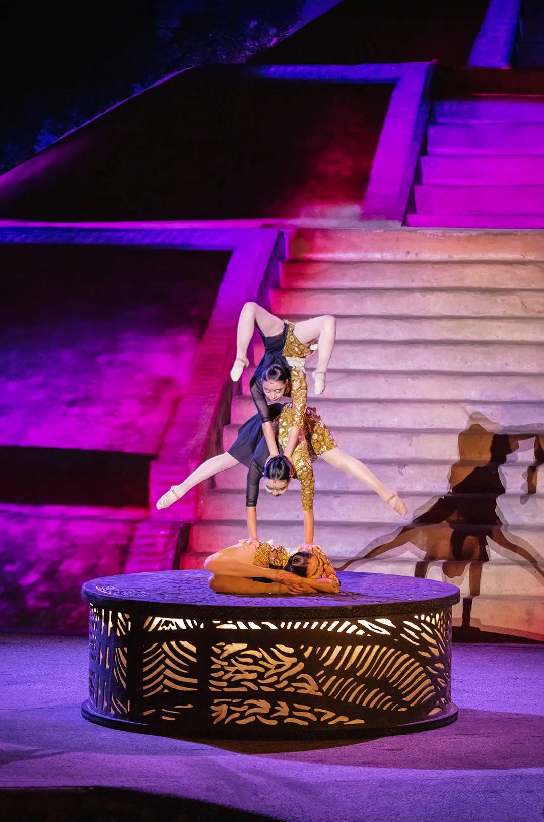 Impressive acrobatic act under colorful lights.