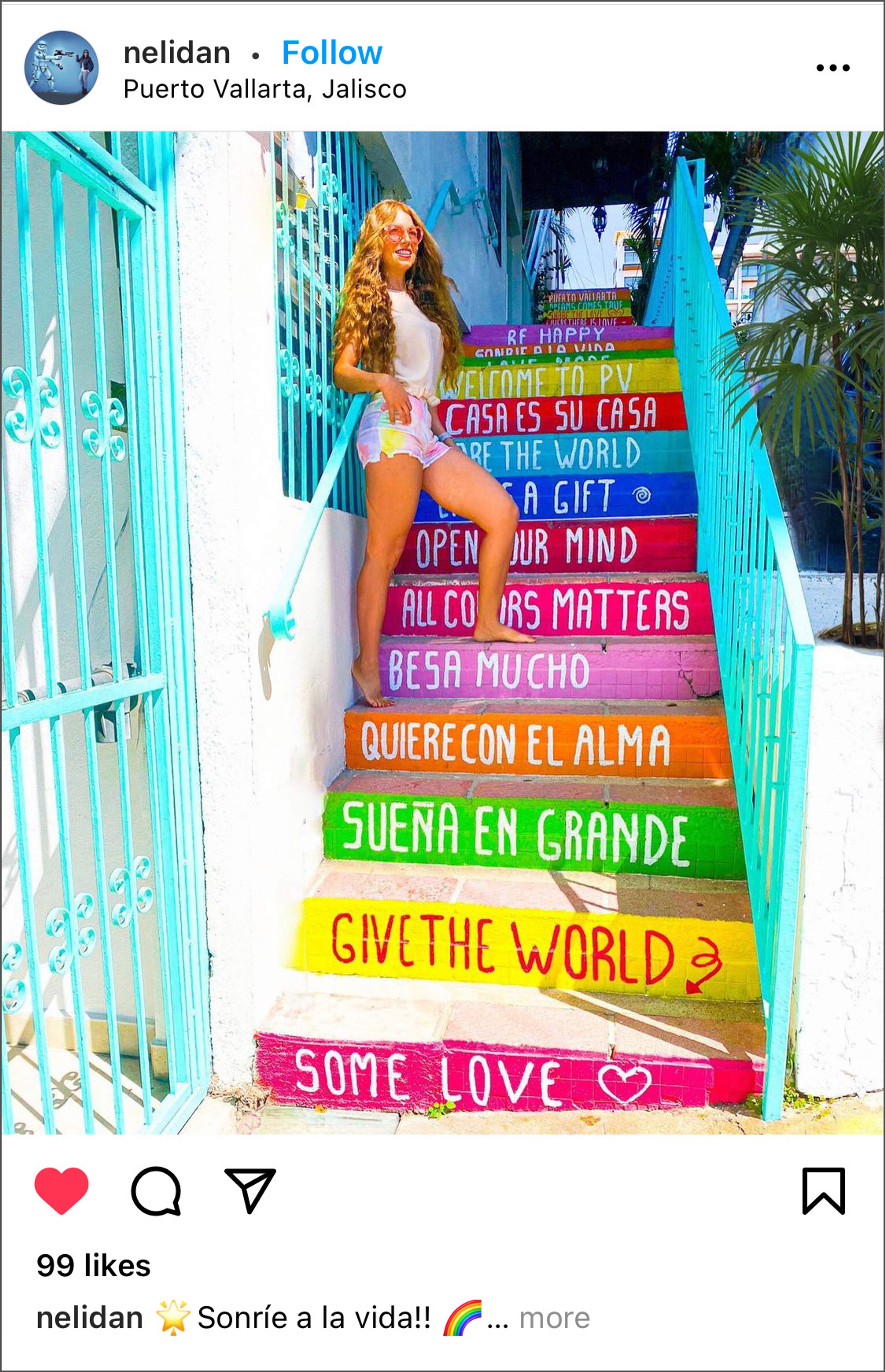 Woman posing on colorful stairs with motivational phrases in Puerto Vallarta, Jalisco.