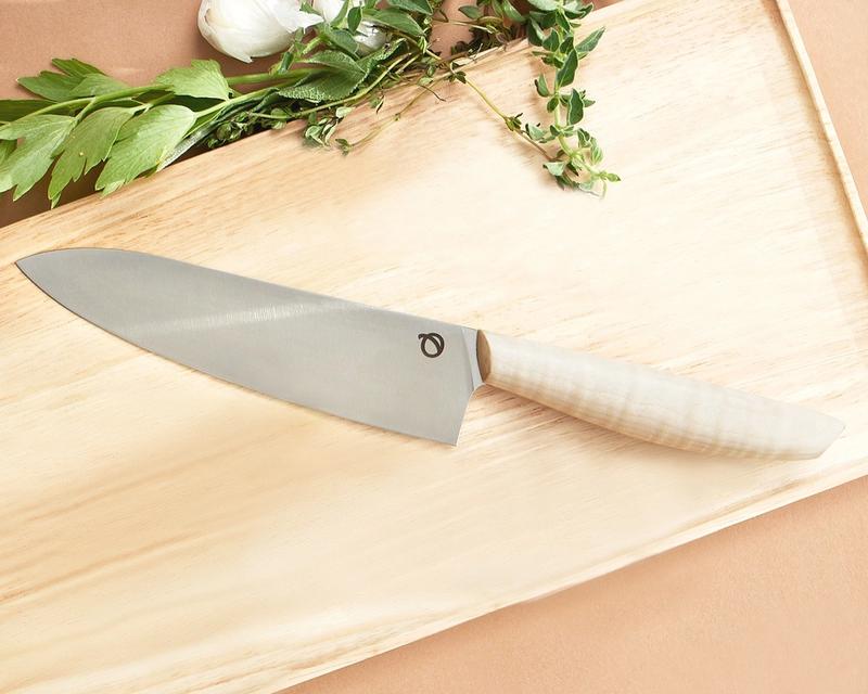 Olavson chef knife from above on cutting board