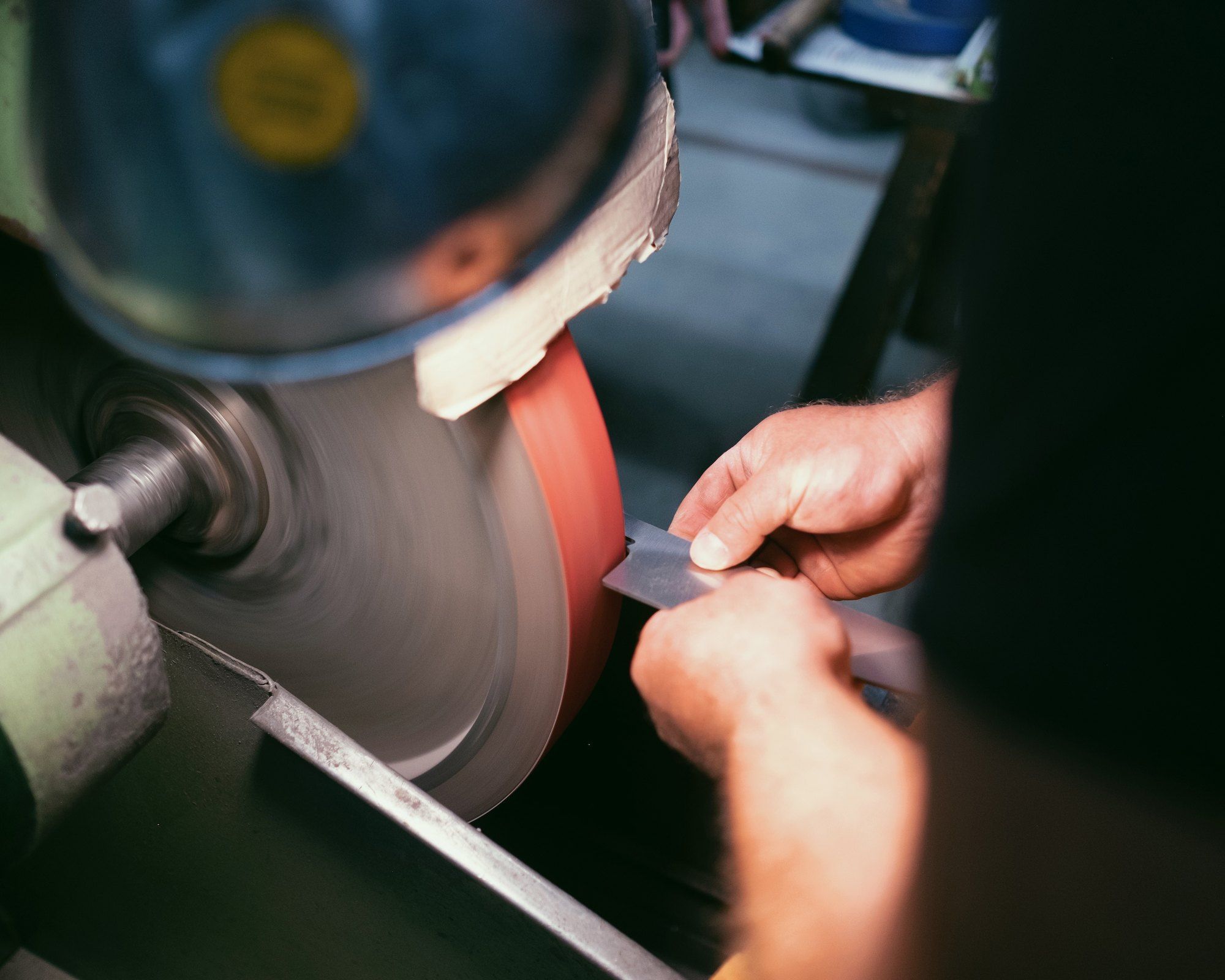 Olav knife being sharpened on high-tech machine