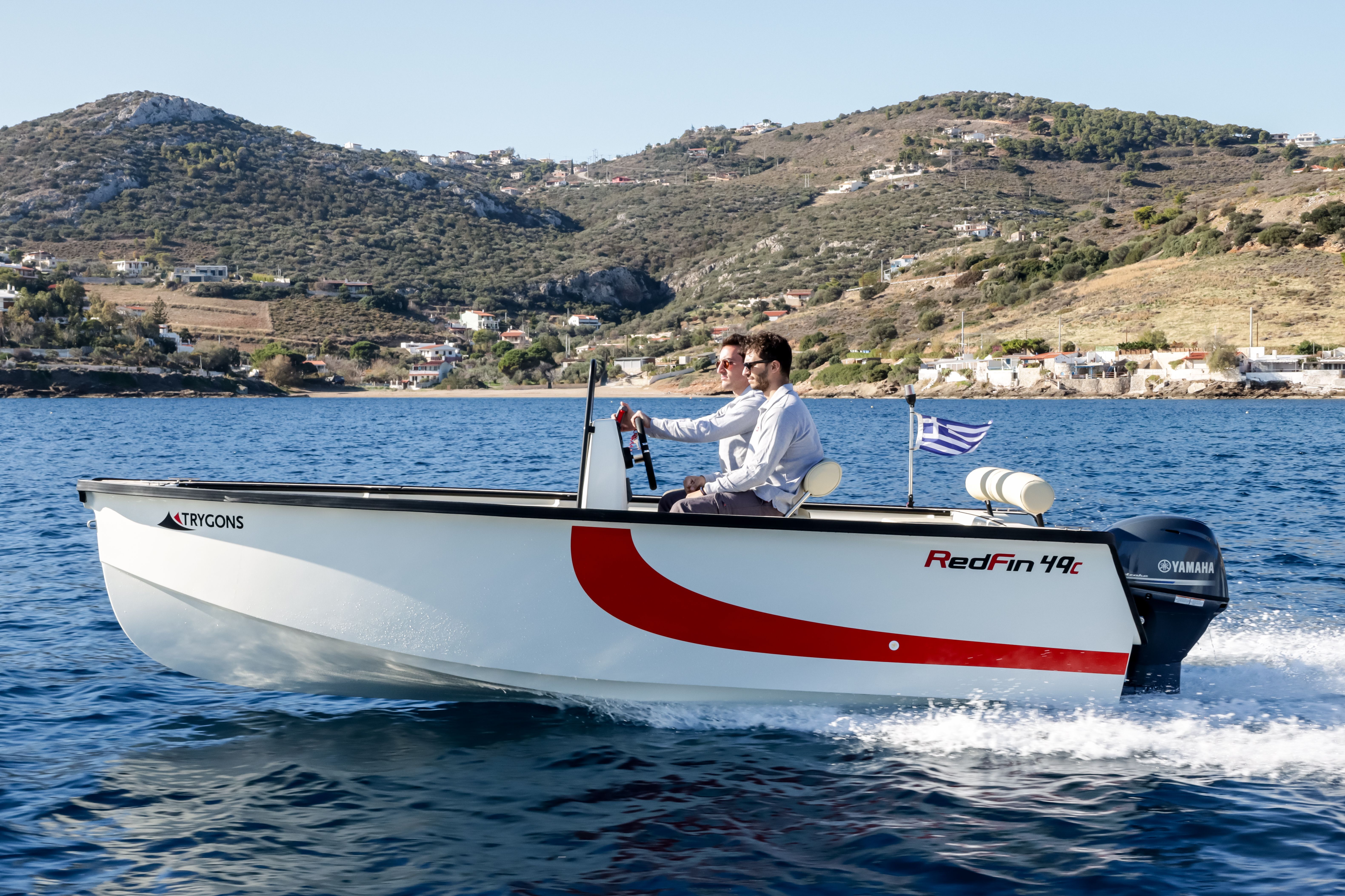 RedFin 49 running, red hull stripe, two crew aboard
