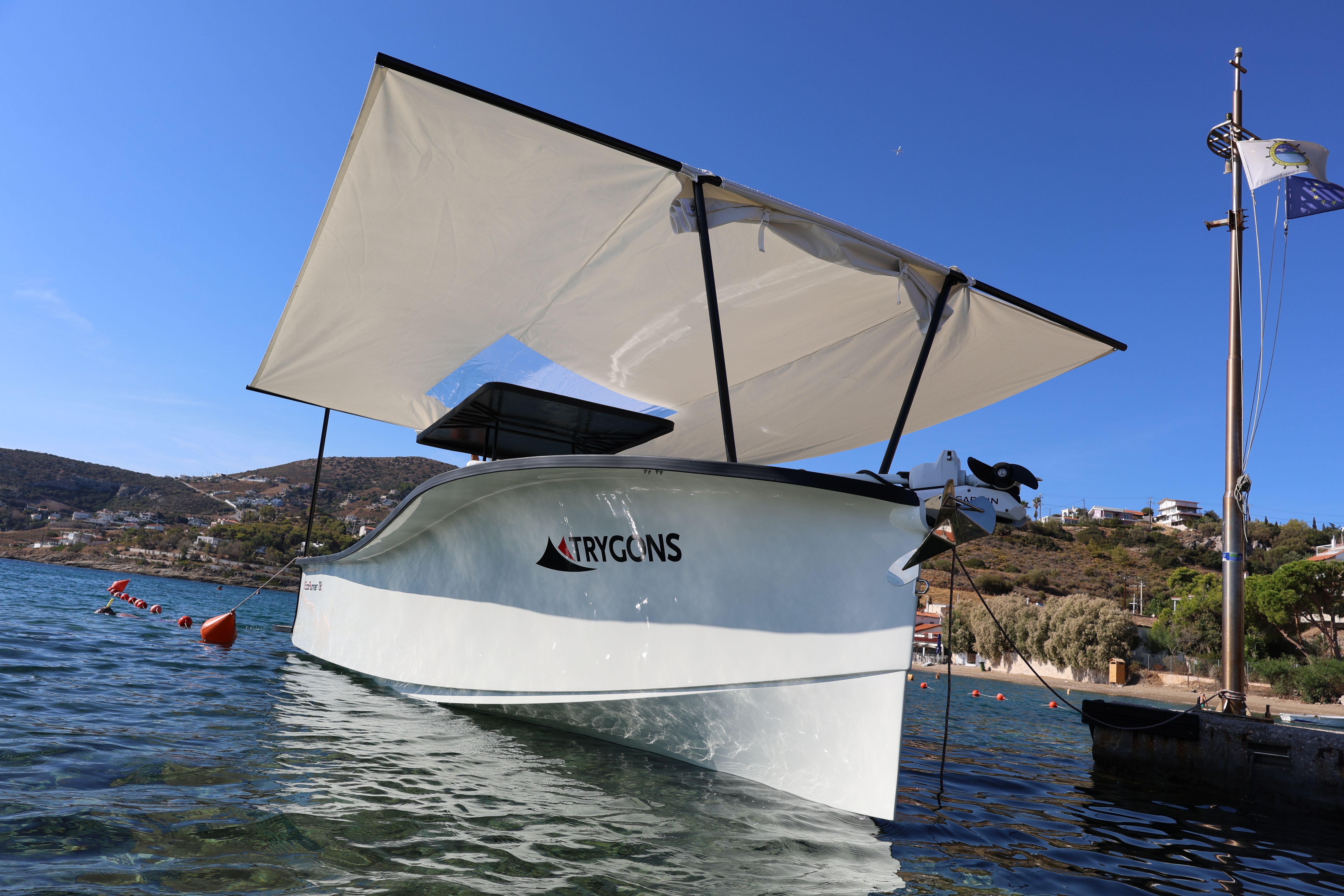 EcoRunner 78 moored with the optional sun awning extended over the T-top