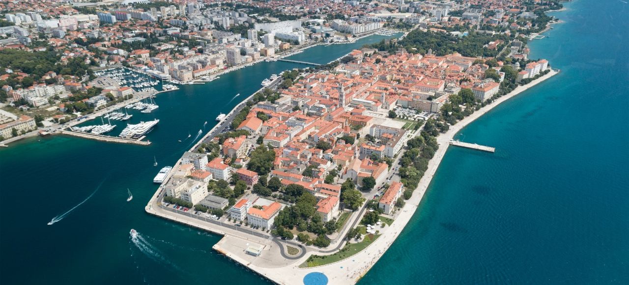 Aerial Panorama of the beautiful city Zadar with its famous Sea Organ located on a peninsula in the mediterranean sea.