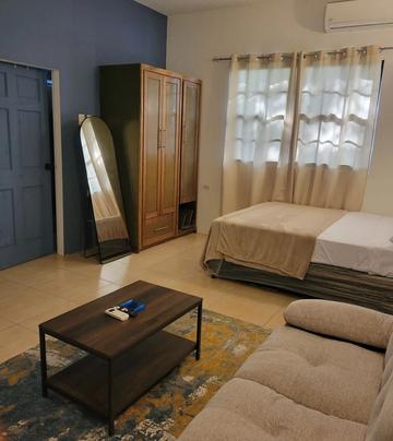Bedroom with a double bed, wooden wardrobe and full-length mirror