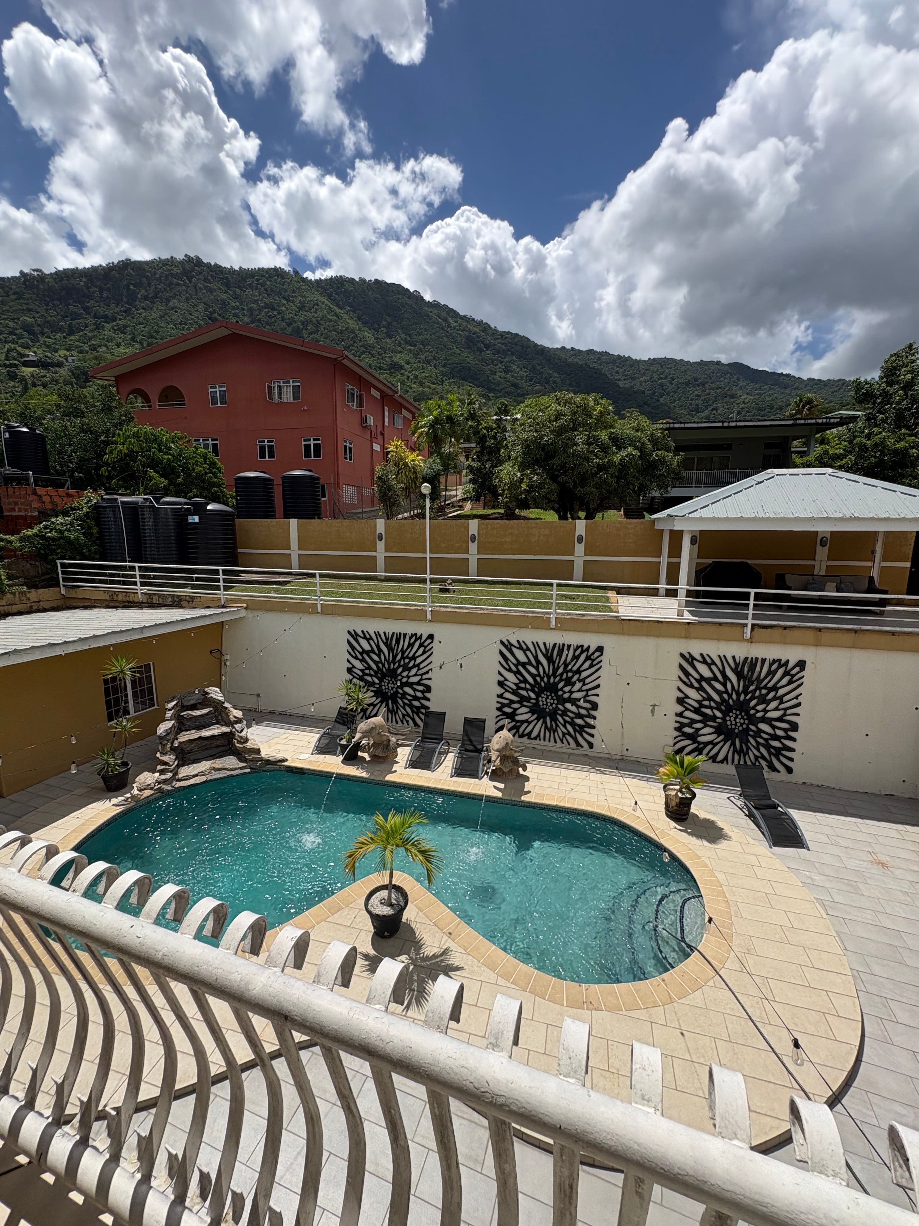 Swimming pool and outdoor seating area at Maracas Valley Villa in St. Joseph, Trinidad.