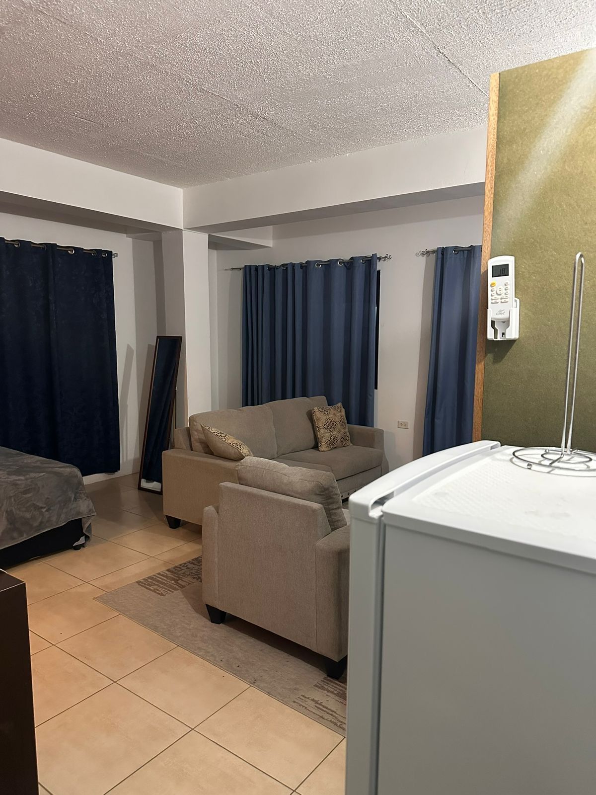 Studio room with a double bed, two-seat sofa and armchair