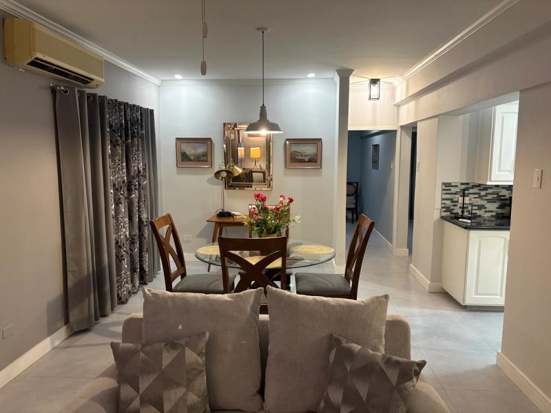 Dining area with beautiful backdrop mirror & art.