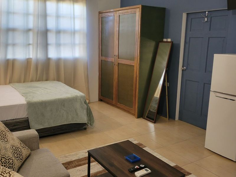 Studio room with a double bed, wardrobe, fridge and sofa