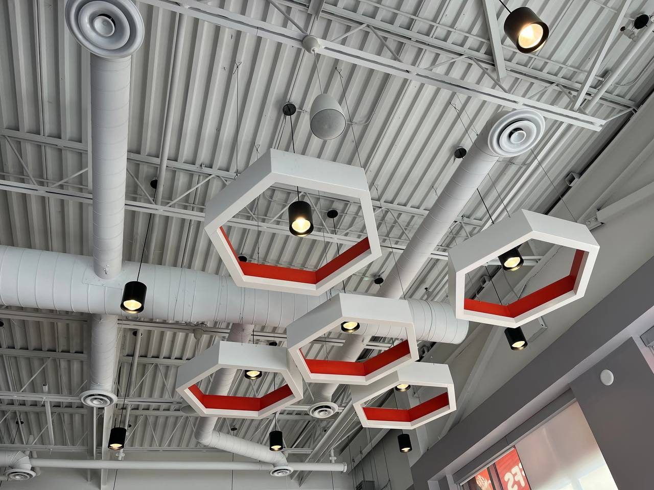 Finished Mr. Puffs café with hexagon feature lights and exposed ductwork