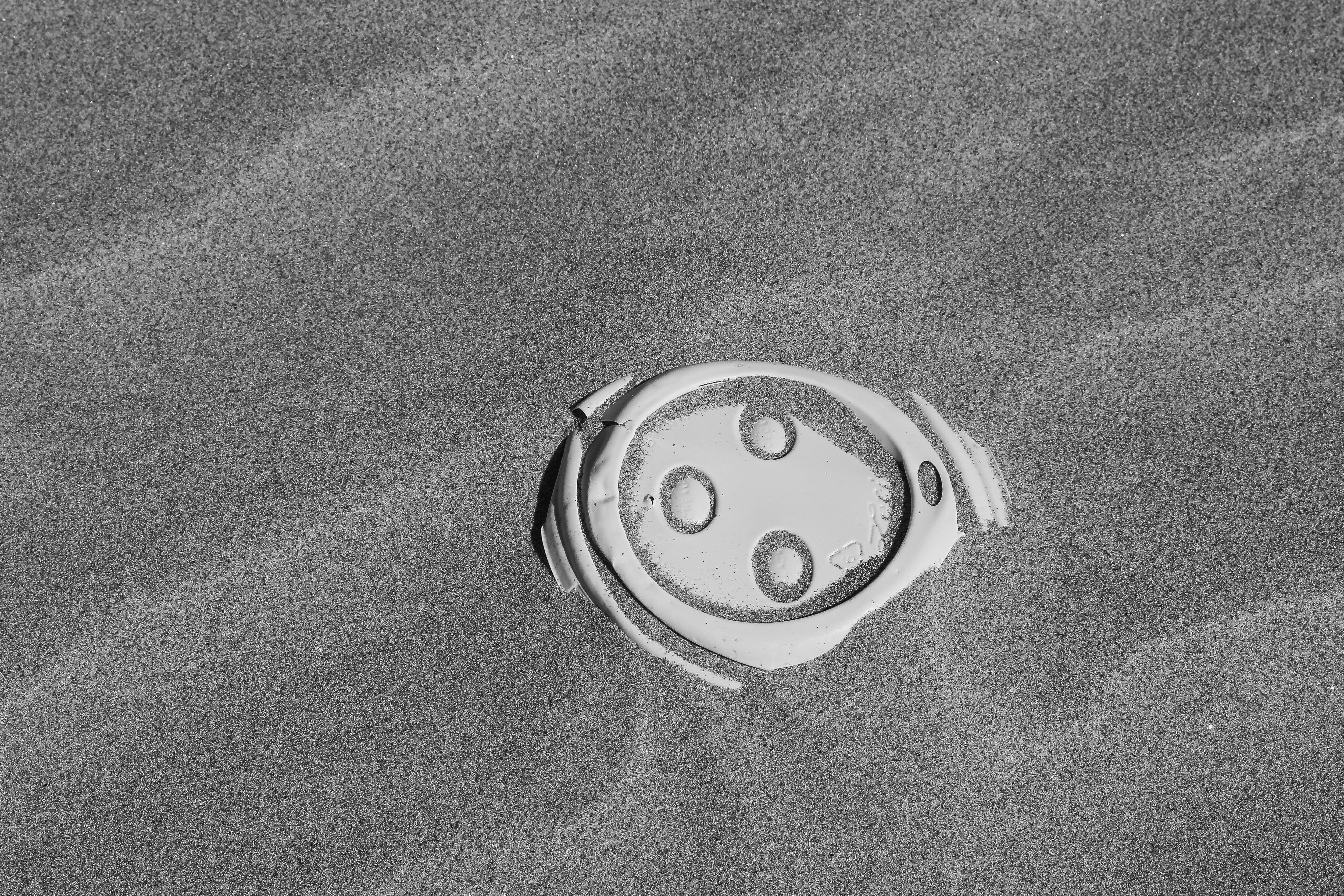Disposed Coffee Lid on the beach