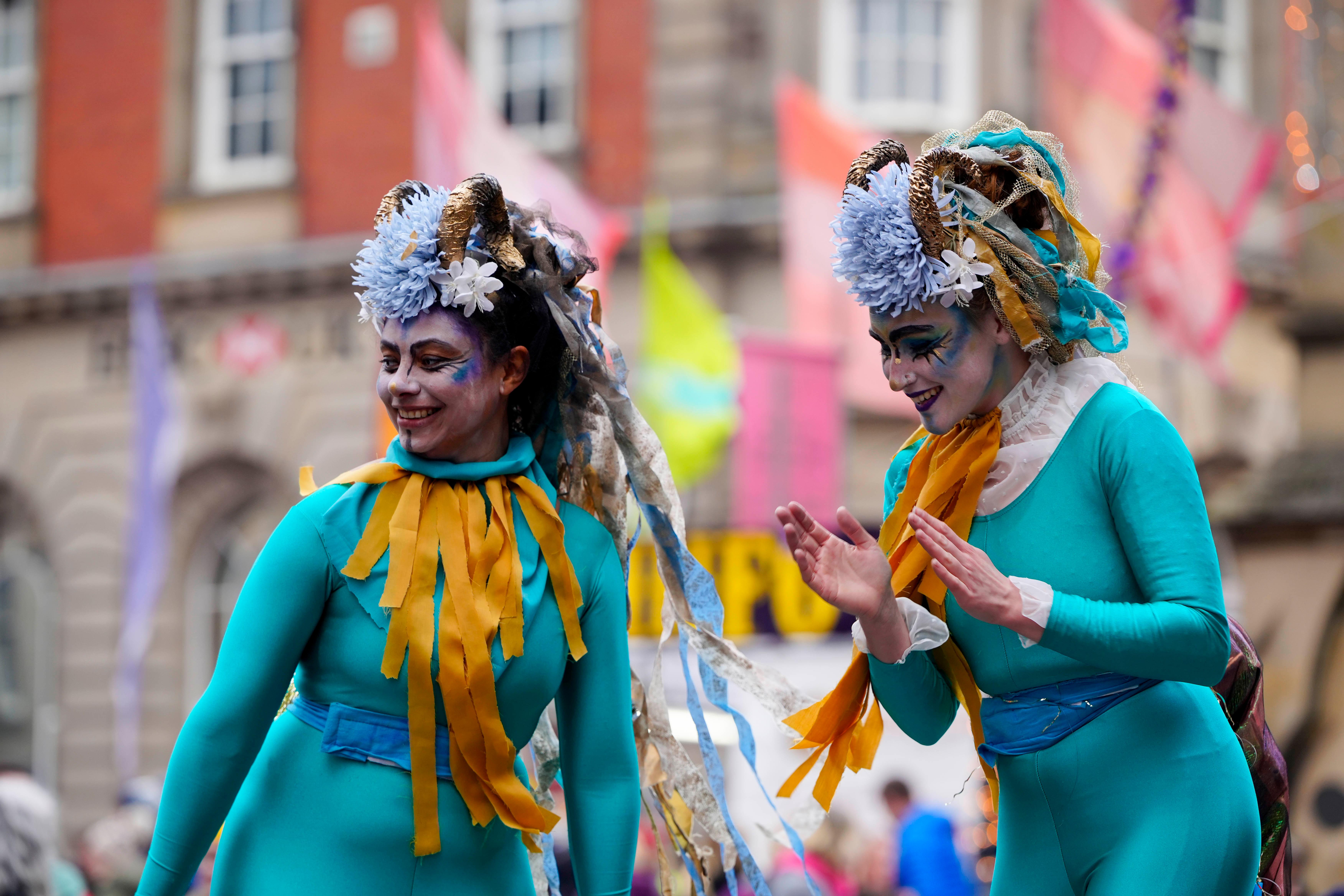 Two circus performers in colourful costumes