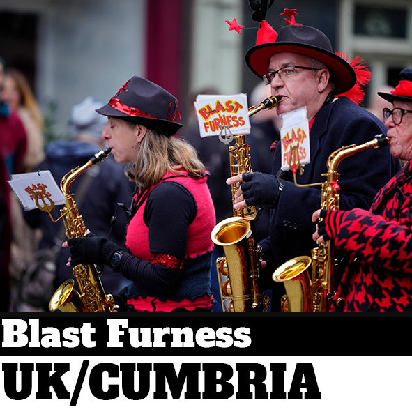 Three people playing saxophones