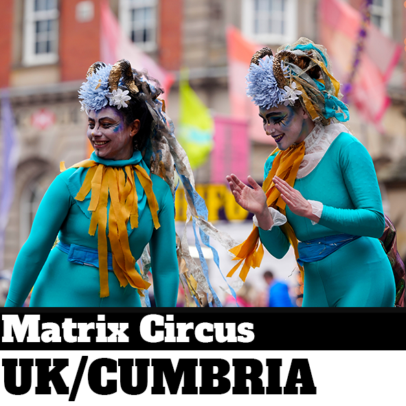 Two performers in colourful costumes