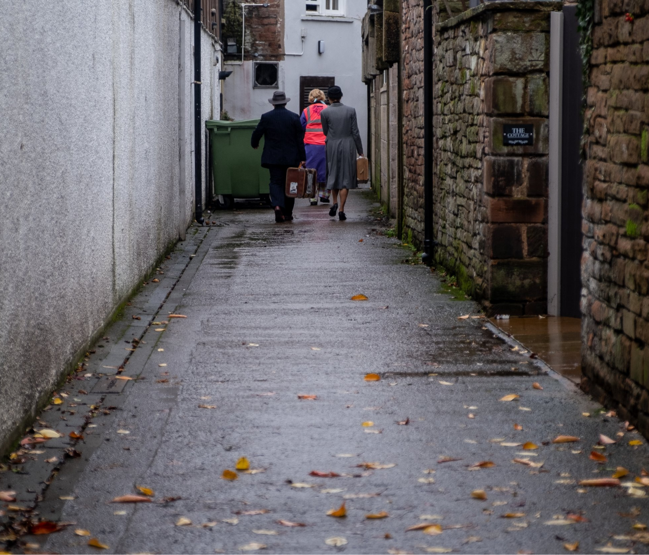 Three people at the end of an alley