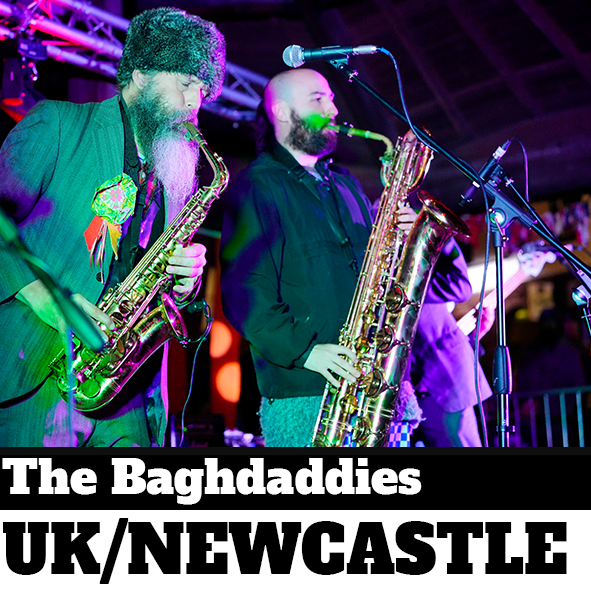 Two band members on stage with saxophones