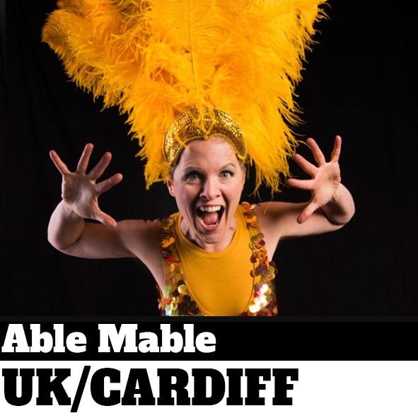Street performer in yellow feather head dress