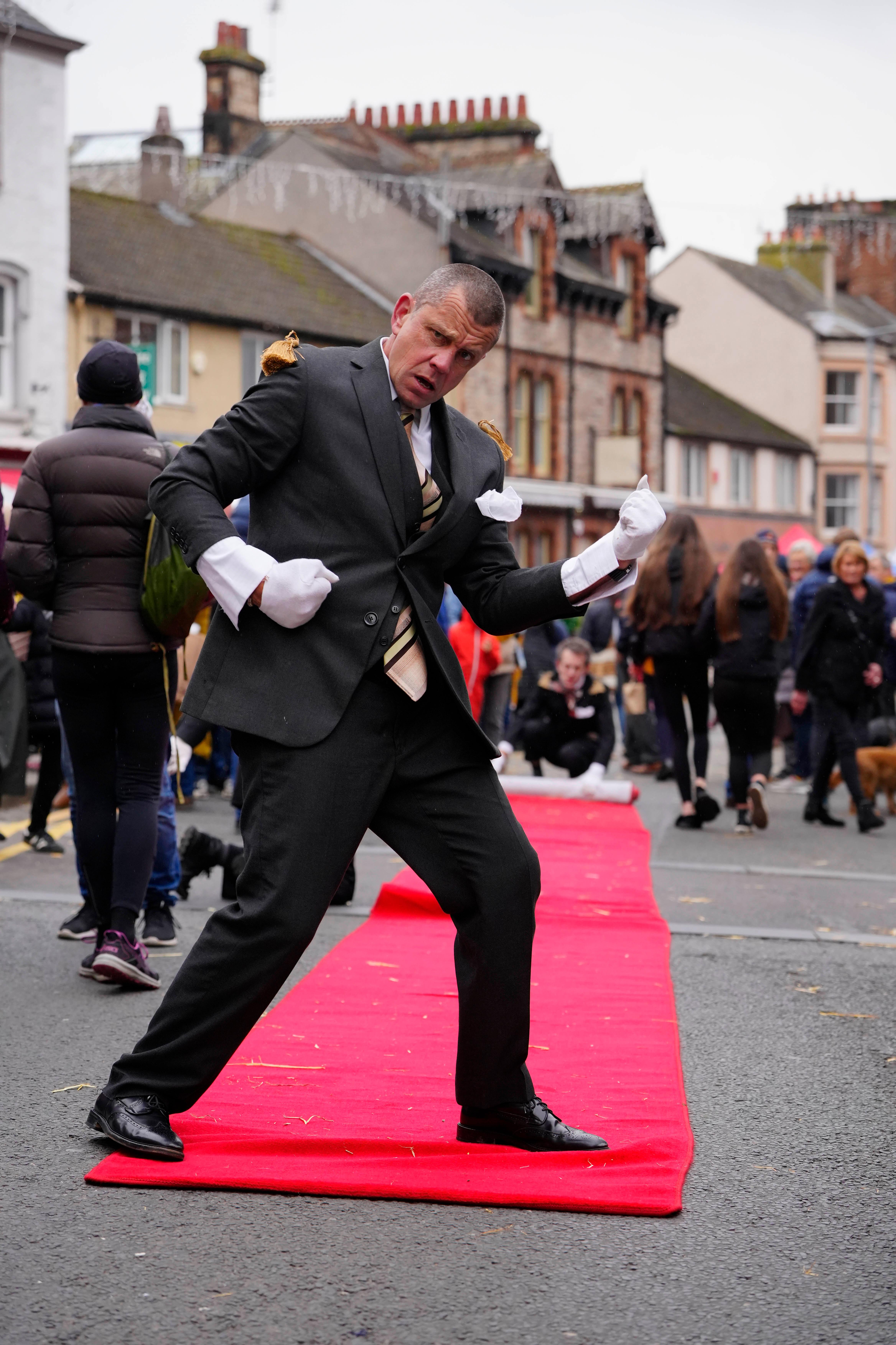 Street performer with rolled out red carpet