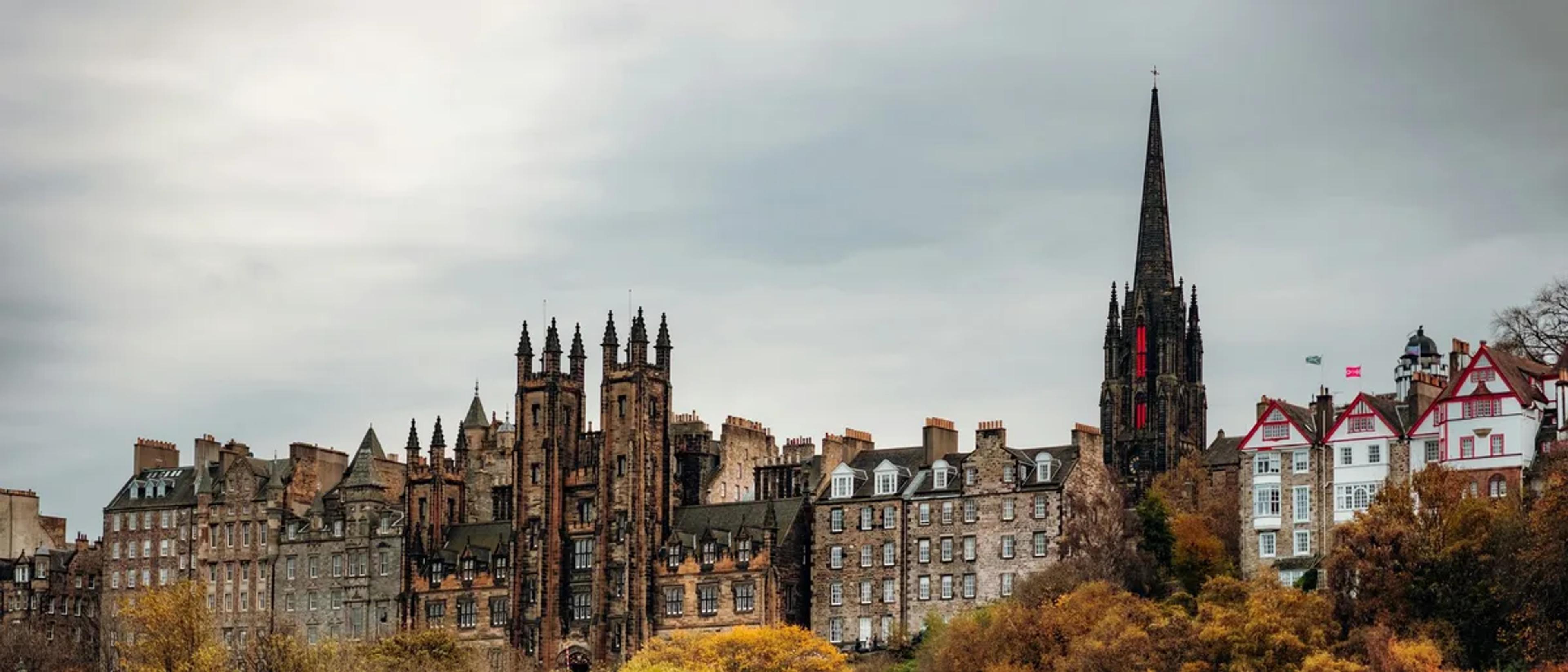 Edinburgh Old Town skyline above autumn trees