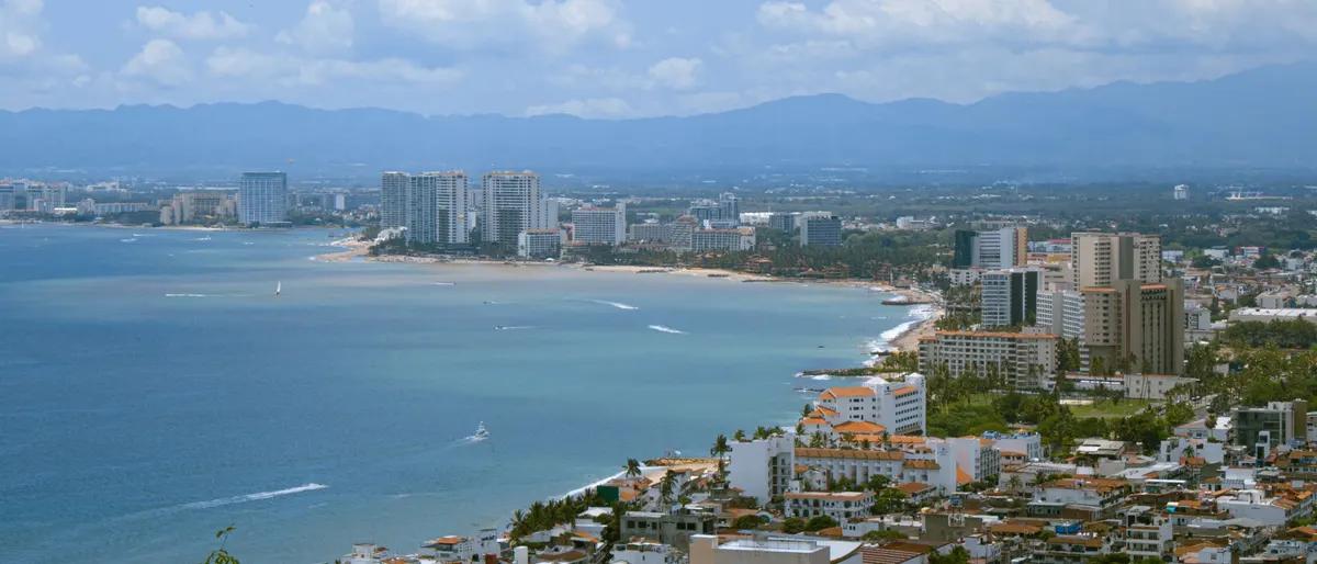 Puerto Vallarta from the hillside, looking north over the Zona Romántica rooftops, the beach and Banderas Bay