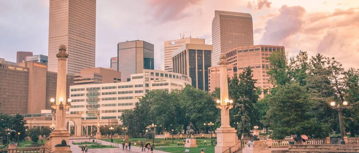 The Denver skyline behind Civic Center Park near Capitol Hill at sunset