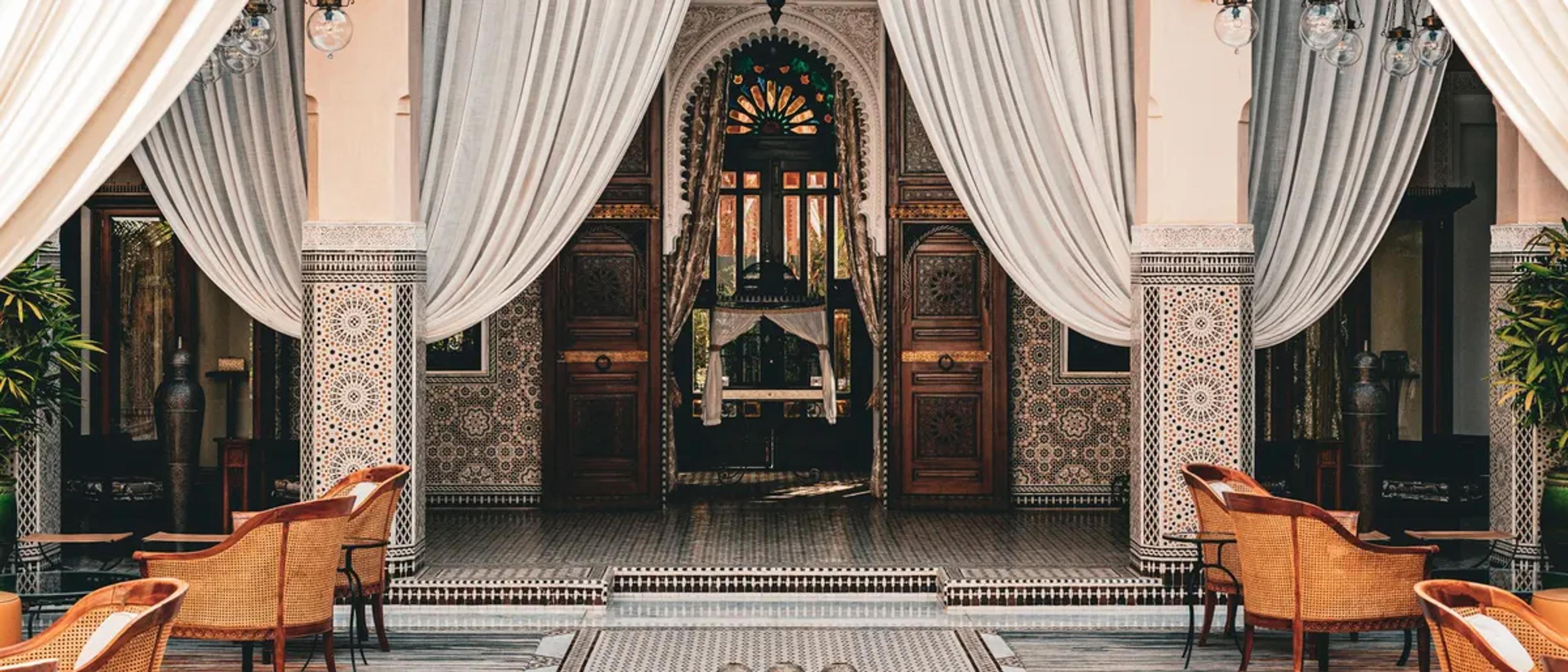 Tiled courtyard with draped arches in a traditional riad in Marrakech, Morocco