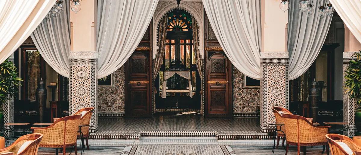 Tiled courtyard with draped arches in a traditional riad in Marrakech, Morocco