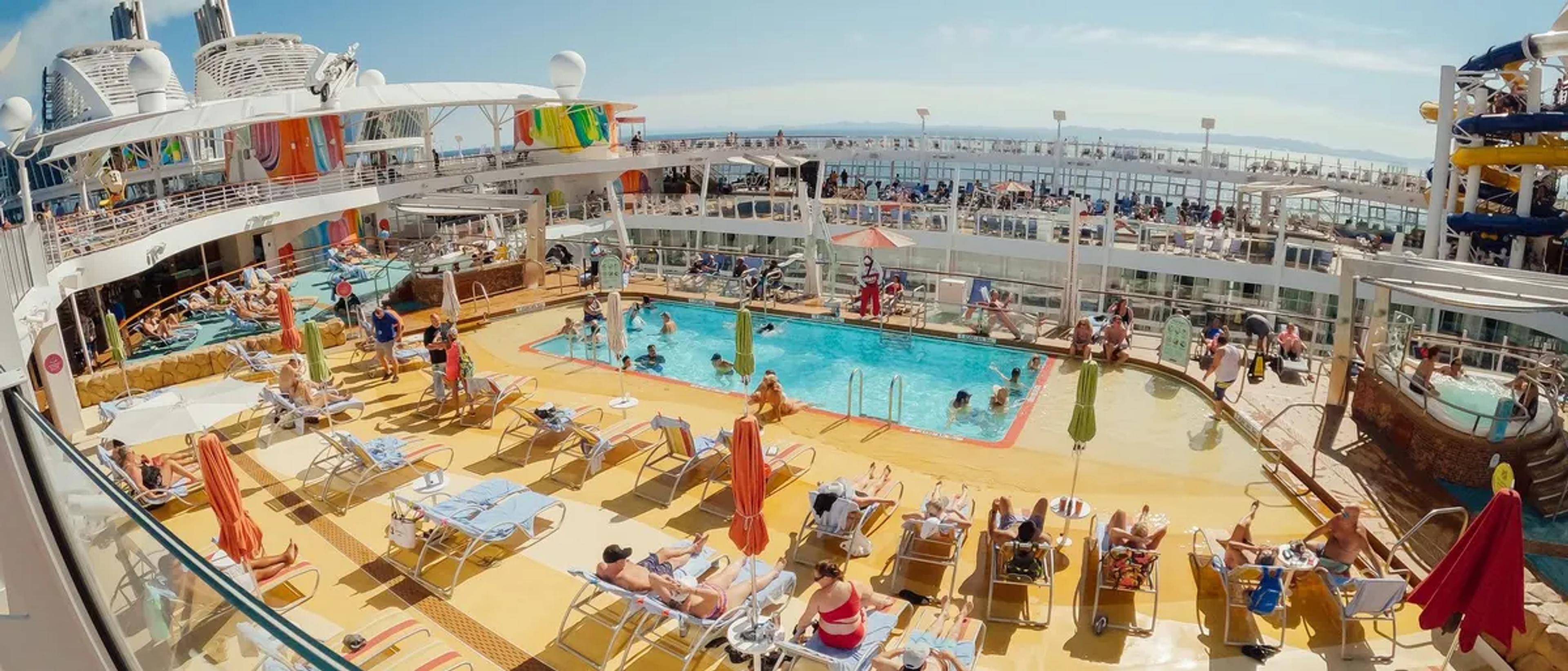 Pool deck of a large Royal Caribbean cruise ship full of sunbathers