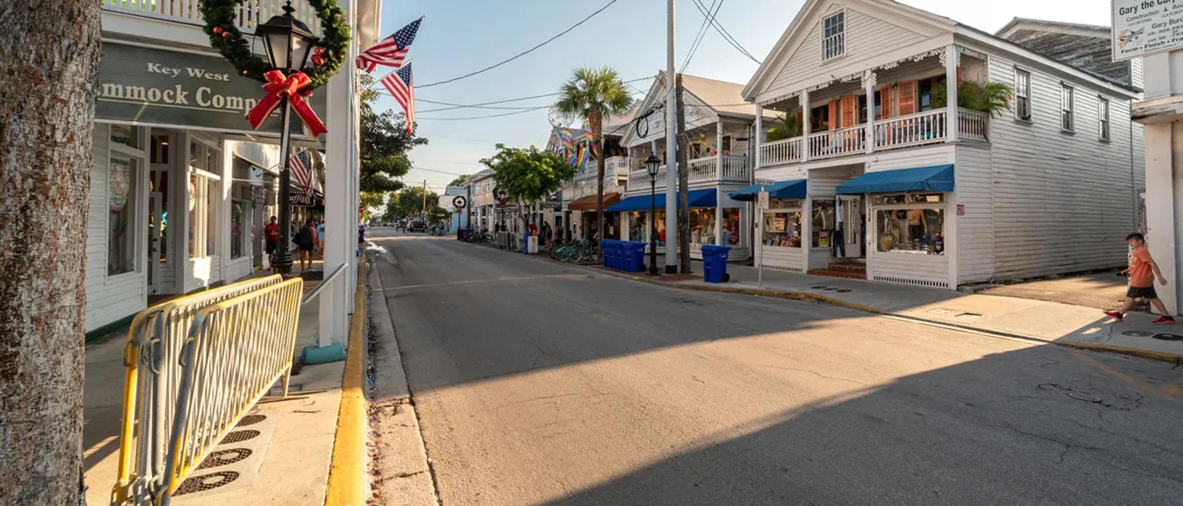 Key West's Duval Street lined with colorful historic storefronts and palms