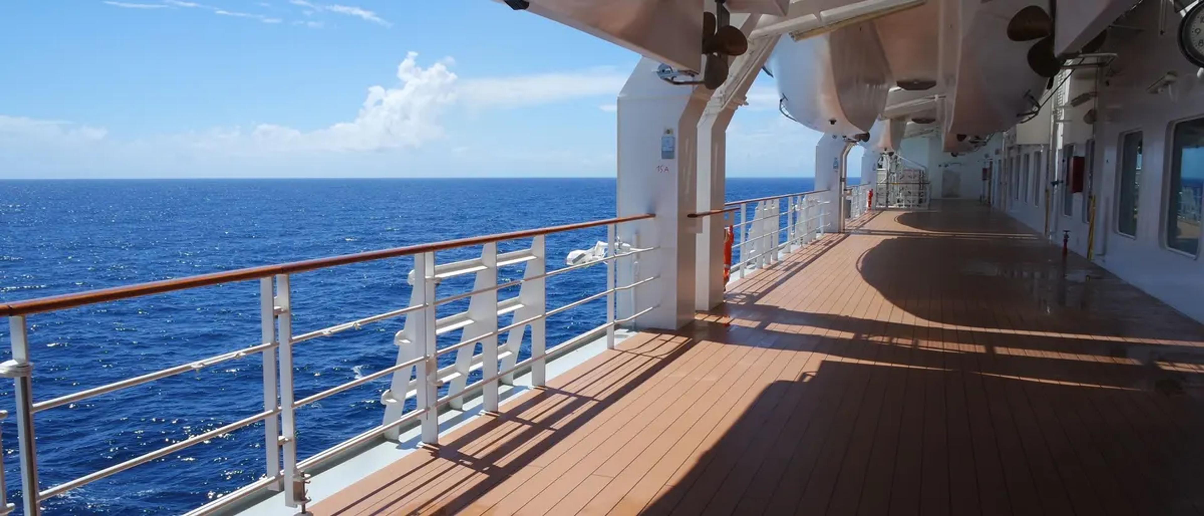 Cruise ship promenade deck overlooking the open blue ocean