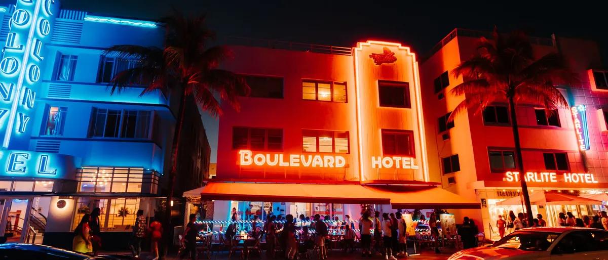 Neon-lit Art Deco hotels on Ocean Drive in Miami Beach at night