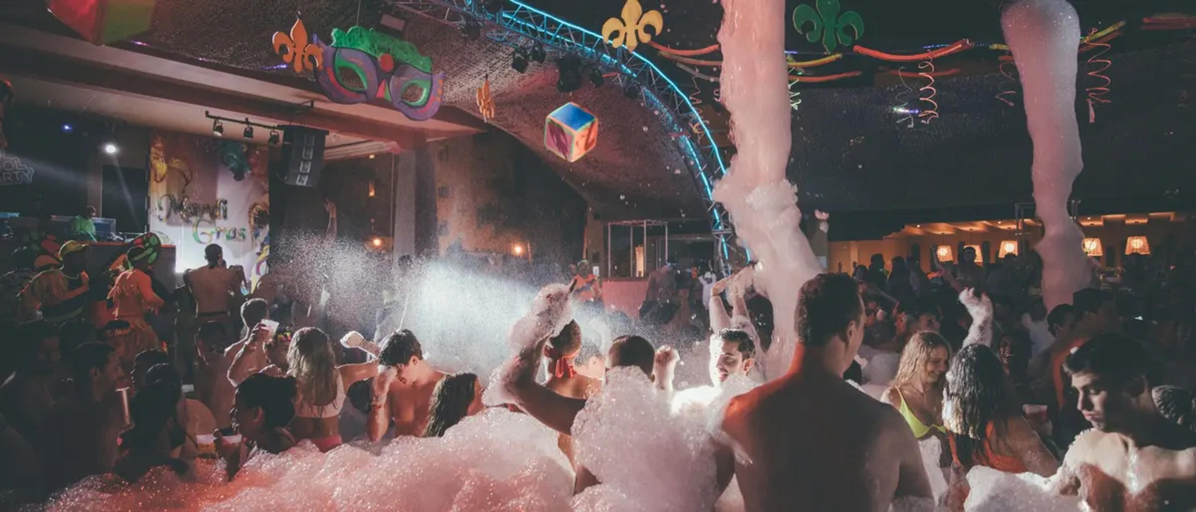 Lively nighttime party crowd celebrating at a festive New Orleans nightlife venue