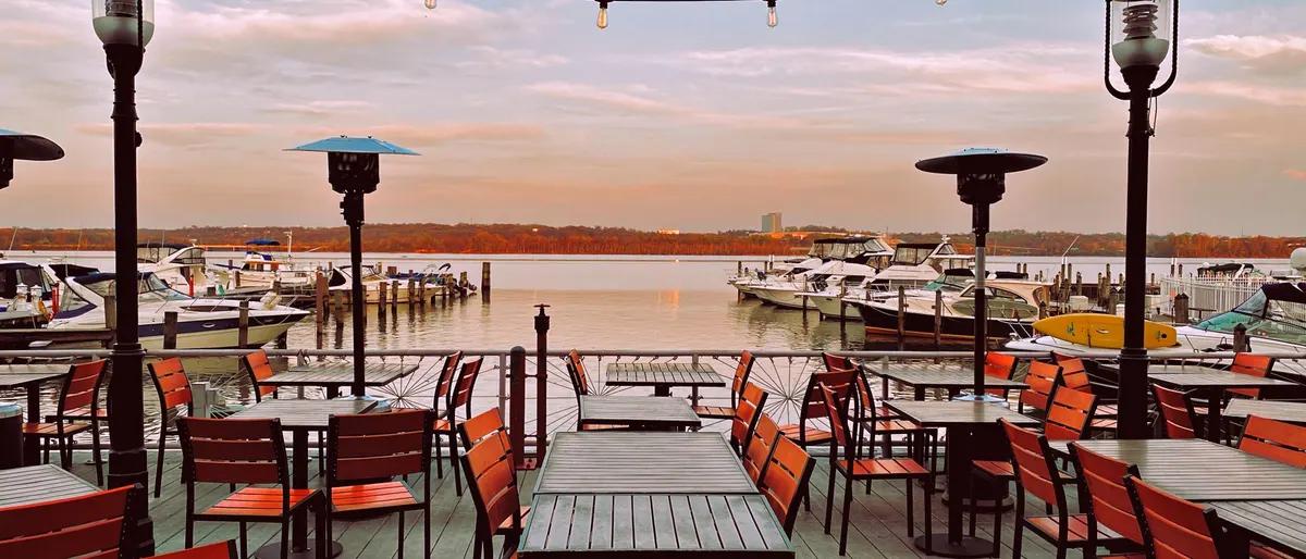 Waterfront restaurant deck overlooking a marina at golden hour