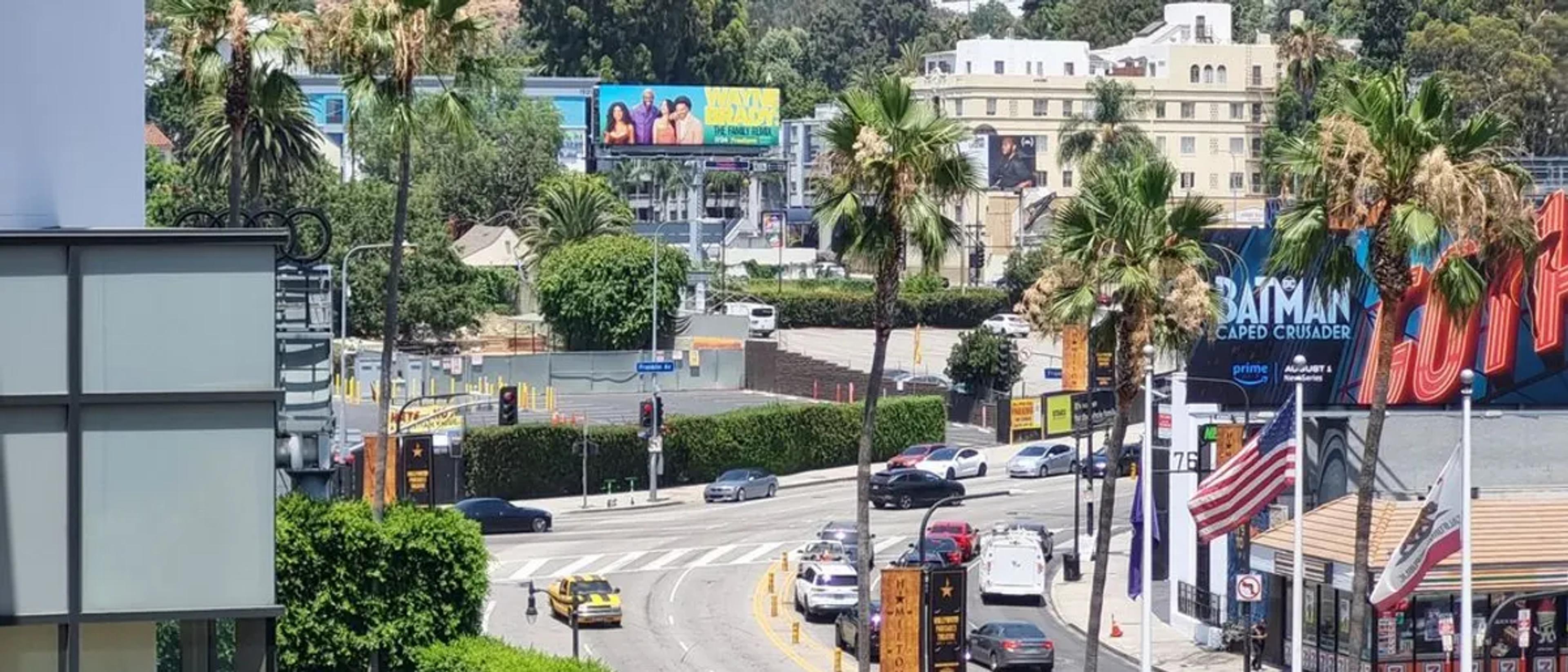 The curving Sunset Strip lined with palm trees and billboards in West Hollywood