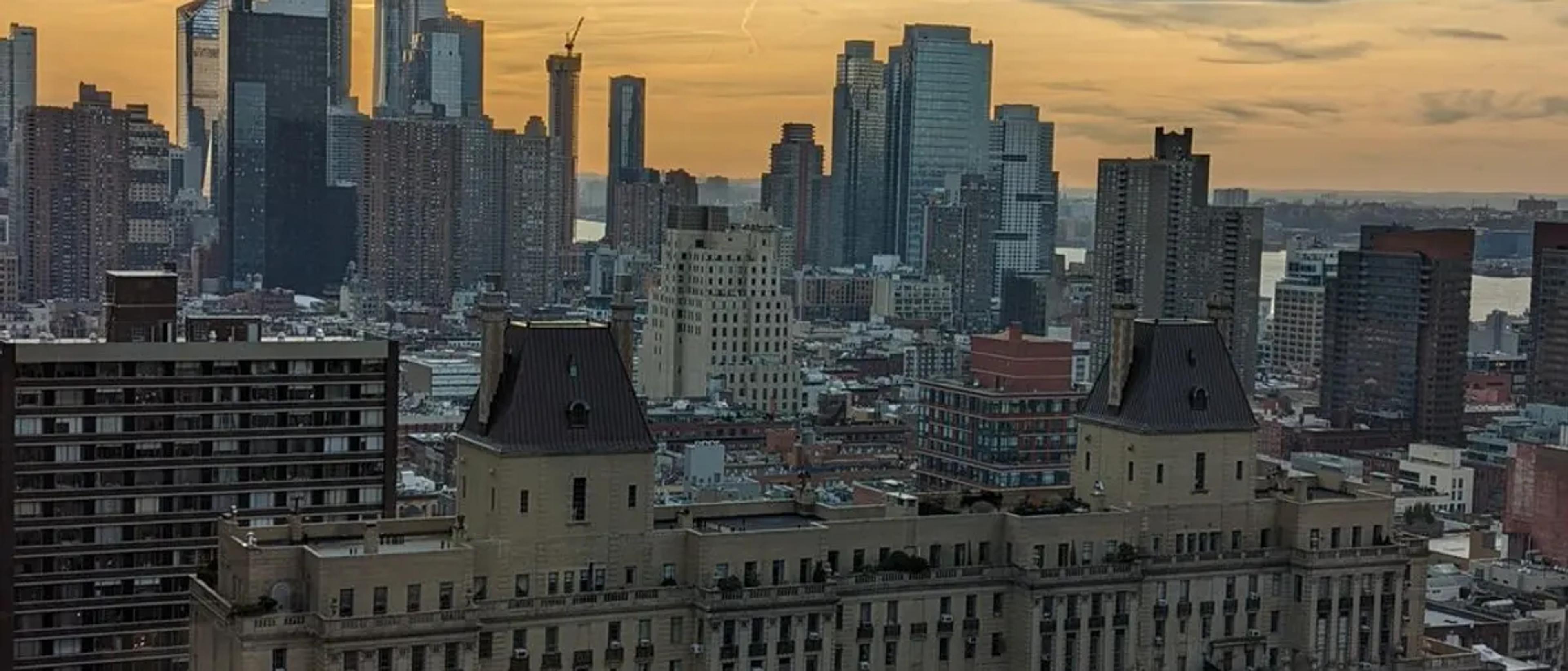 The Midtown Manhattan skyline at golden hour above the rooftops of Hell's Kitchen
